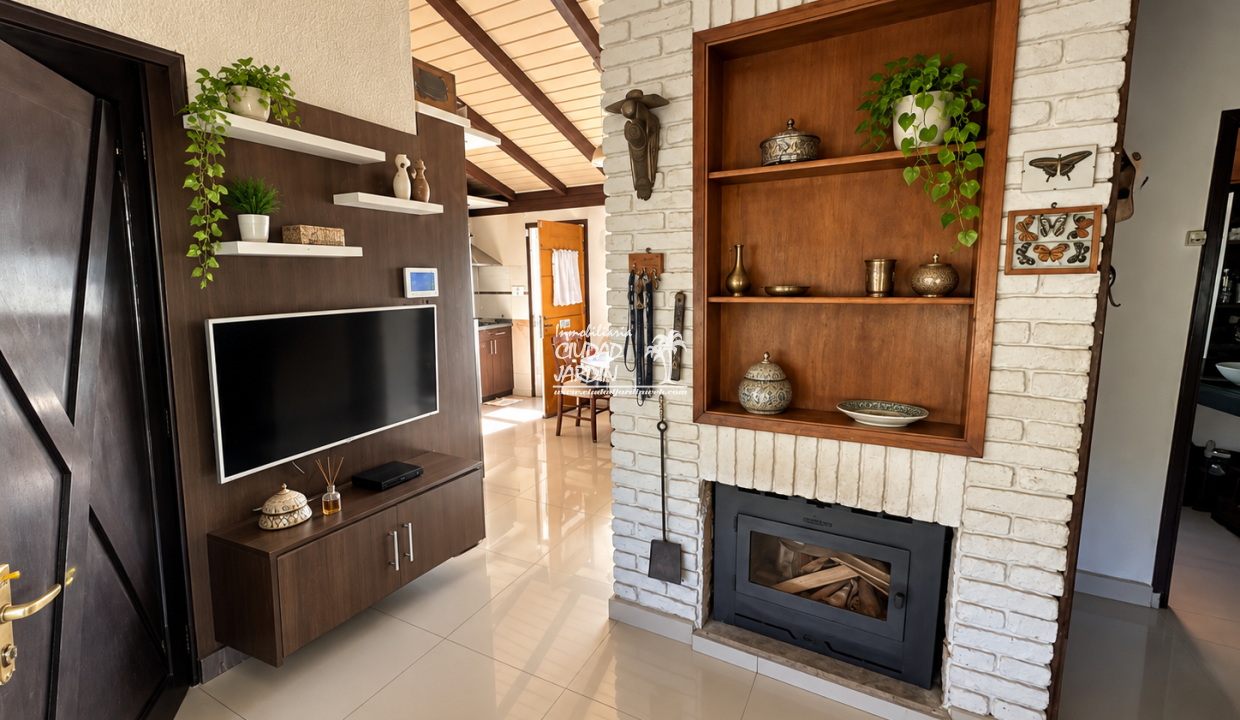 Salón rústico con chimenea y TV